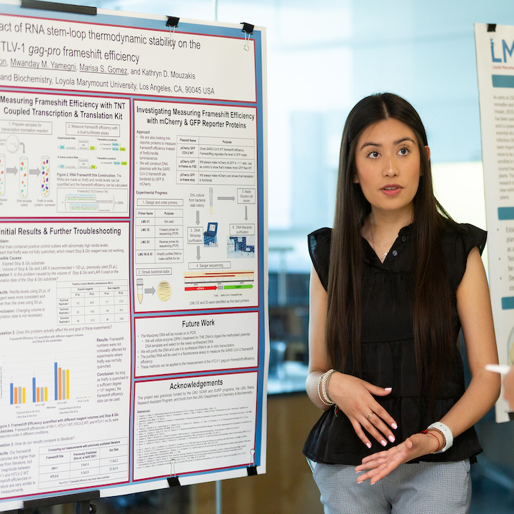 Student next to a research poster